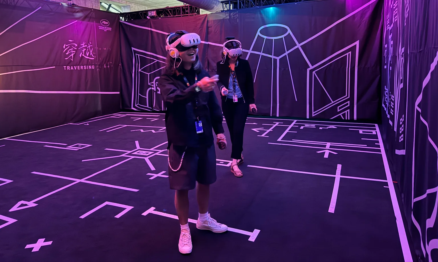 Participants wearing VR headsets inside the purple exhibition space of Traversing the Mist